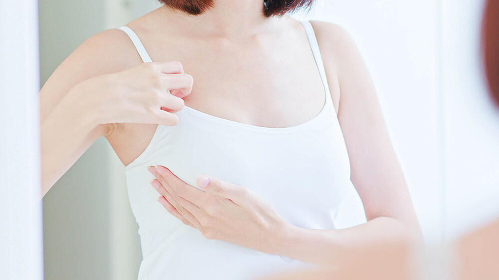 Woman examining her own breasts