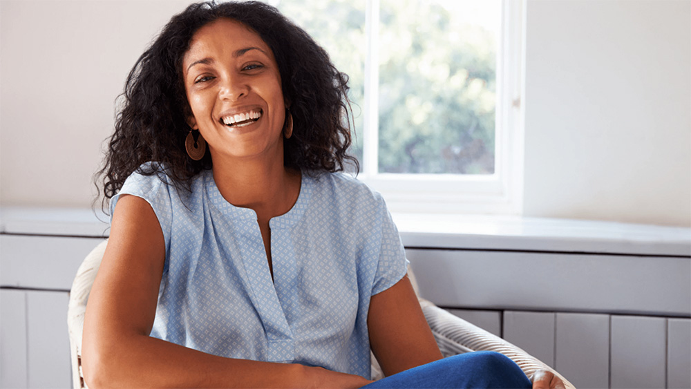 Woman smiling sitting in a chair