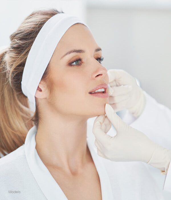 Beautiful woman getting face examed