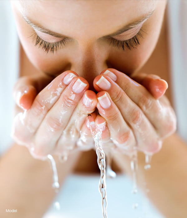 Woman washing her face