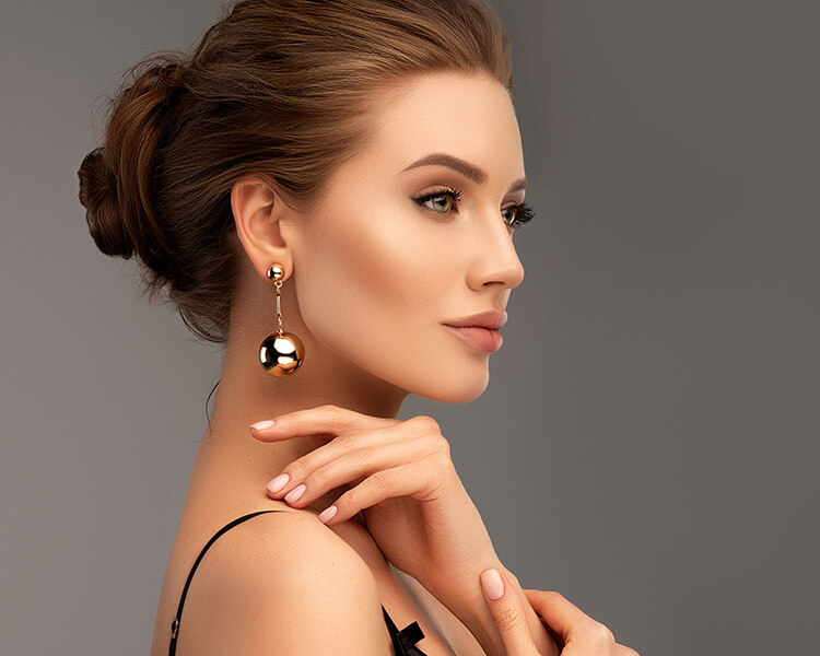Elegant woman with gold earings