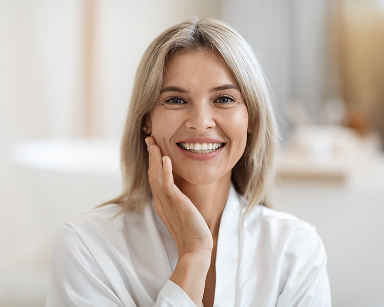 Mature woman touching her face